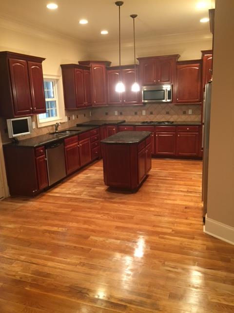 1615 Fair House Road Spring Hill, TN 37174 - Photo 11 of 19 a kitchen with stainless steel appliances granite countertop a sink counter space cabinets and wooden floor