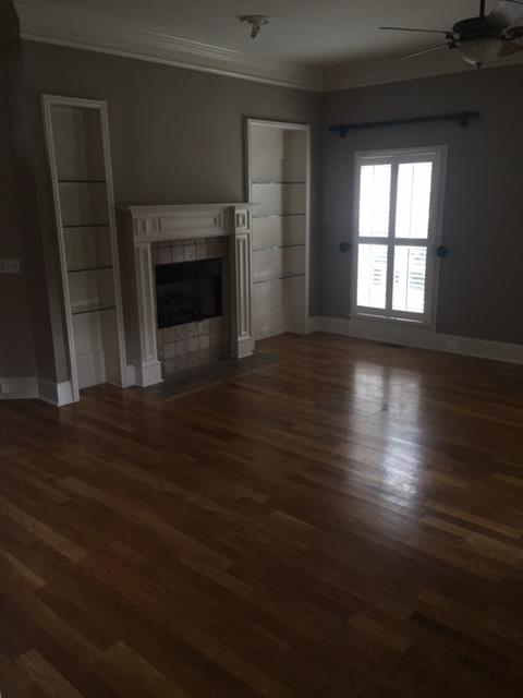 1615 Fair House Road Spring Hill, TN 37174 - Photo 13 of 19 an empty room with wooden floor fireplace and windows