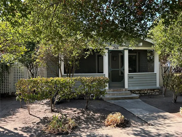 a view of a house with a yard and a garden