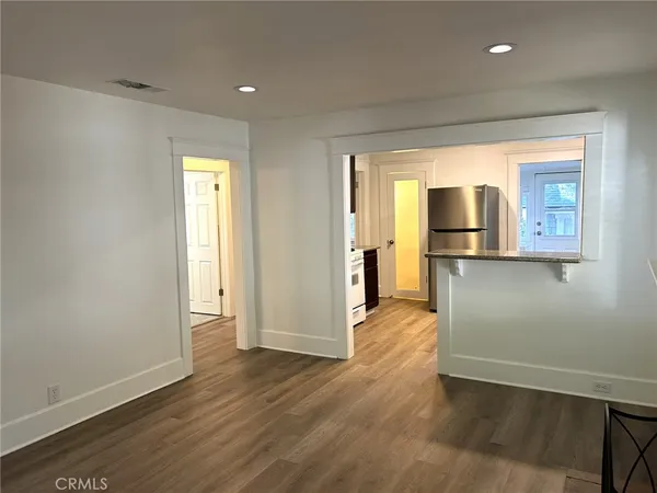 a view of a hallway with wooden floor