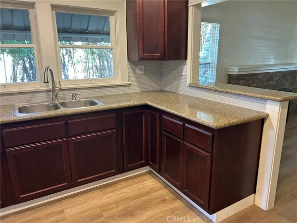a kitchen with a sink and wooden cabinets