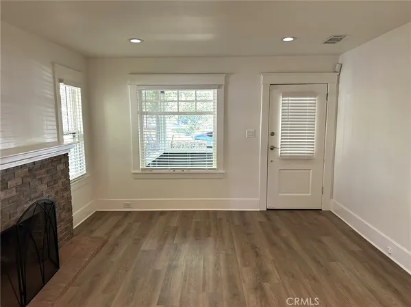 a view of a kitchen with wooden floor and a refrigerator