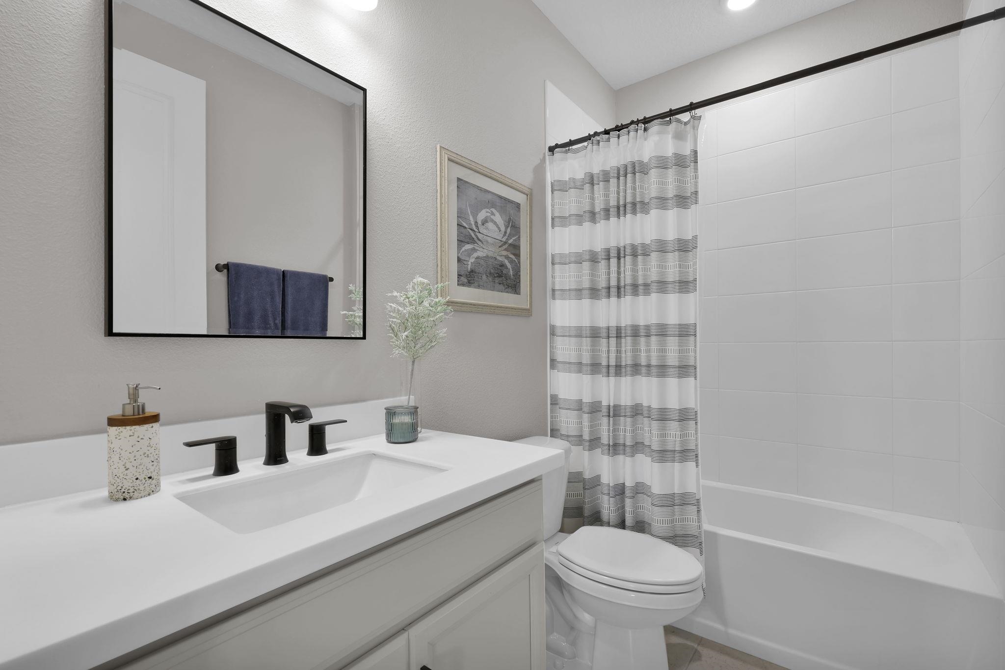 32 Martha Ct. St. Augustine, FL 32092 - Photo 18 of 36 a bathroom with a sink a toilet and shower curtain