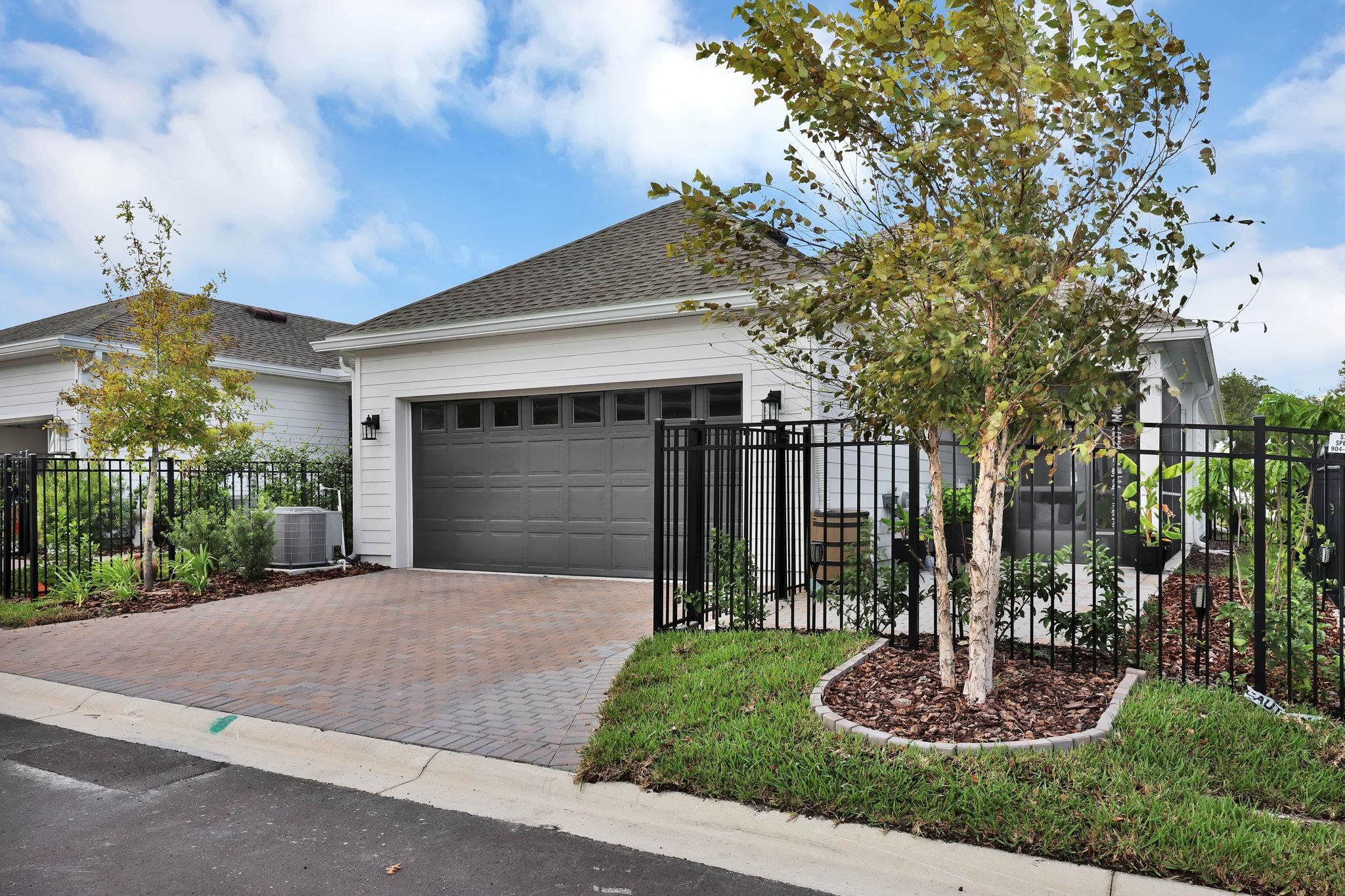 32 Martha Ct. St. Augustine, FL 32092 - Photo 23 of 36 a front view of a house with a yard and potted plants