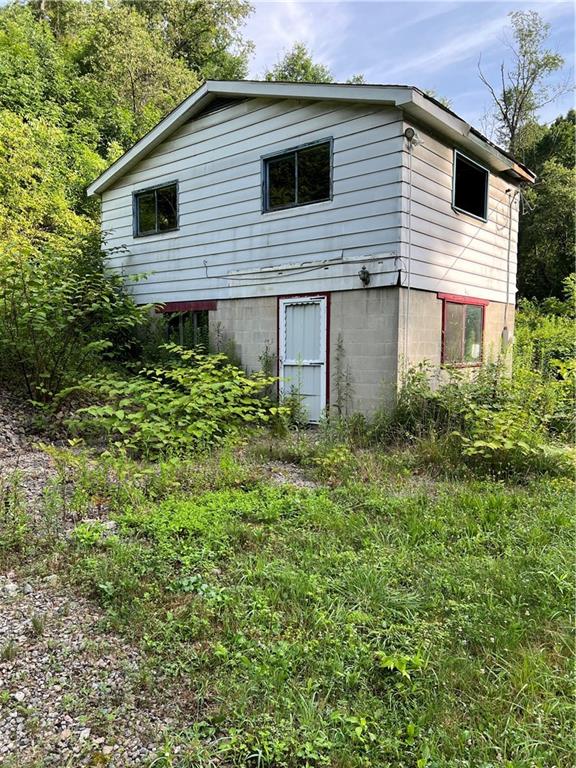 138 Friendship Road Beaver Falls, PA 15010 - Photo 3 of 15 a backyard of a house with plants and tree