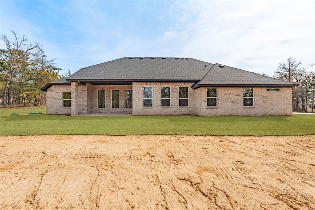 2017 Forest Bridge Azle, TX 76020 - Photo 29 of 30 Back of house featuring brick siding, a patio, a yard, and roof with shingles