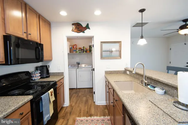 a kitchen that has a sink and a stove in it