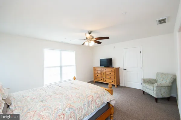 a bedroom with a bed and a couch