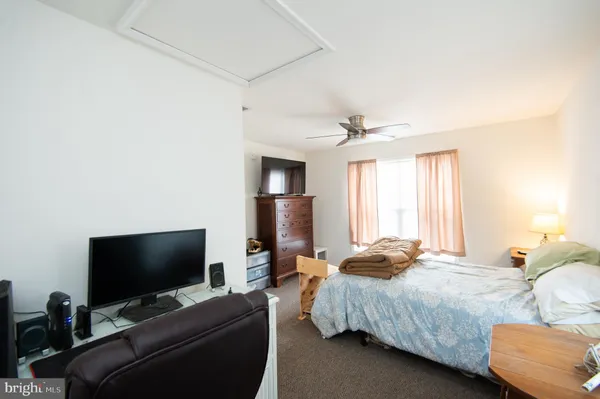 a bedroom with two beds and a flat screen tv
