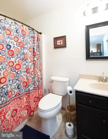 a bathroom with a toilet a sink and a mirror