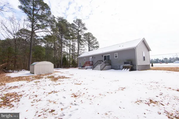 a view of a house with snow on the road