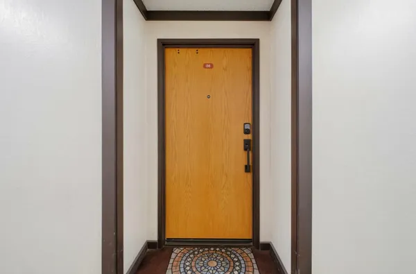 a view of a hallway with a door and a door