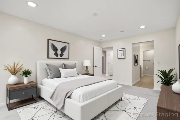 a spacious bedroom with a bed and a painting on the wall