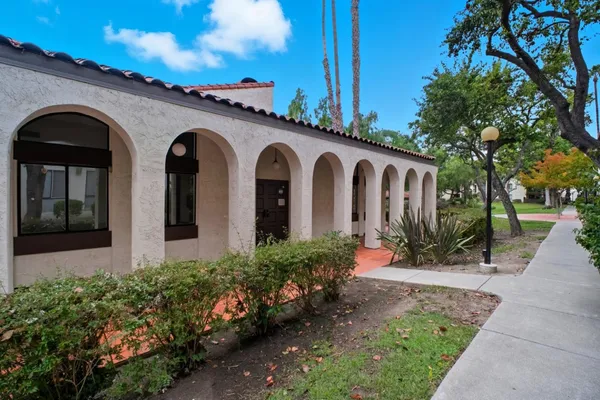 a view of a livingroom with wooden floor and a fireplace