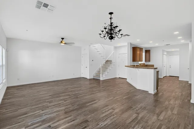 a view of a kitchen with a sink wooden floor and a kitchen view
