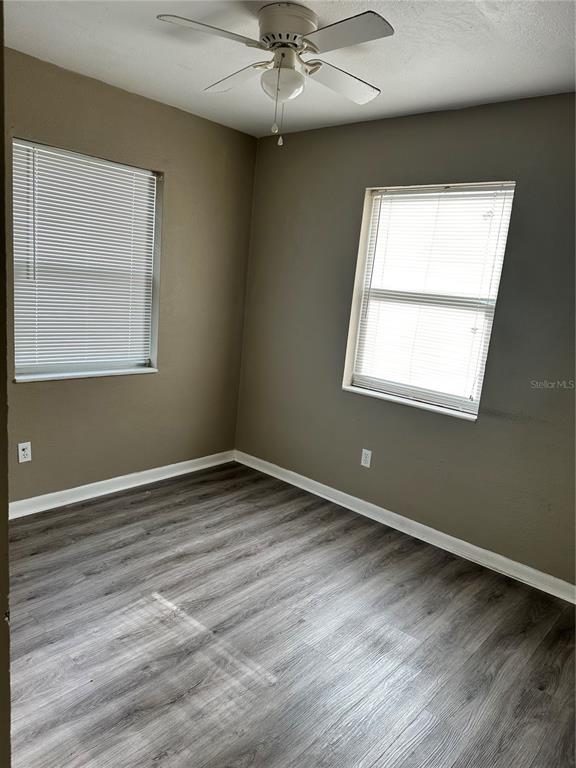 2302 Idaho Road Deltona, FL 32738 - Photo 14 of 22 an empty room with wooden floor and windows