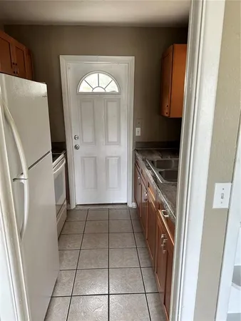 a kitchen with sink and mirror