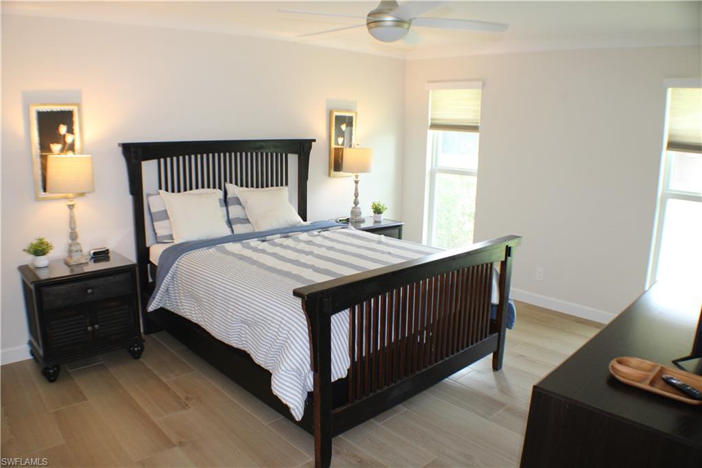 809 Palm View Drive, Unit 8 Naples, FL 34110 - Photo 12 of 26 a bedroom with a bed and a window