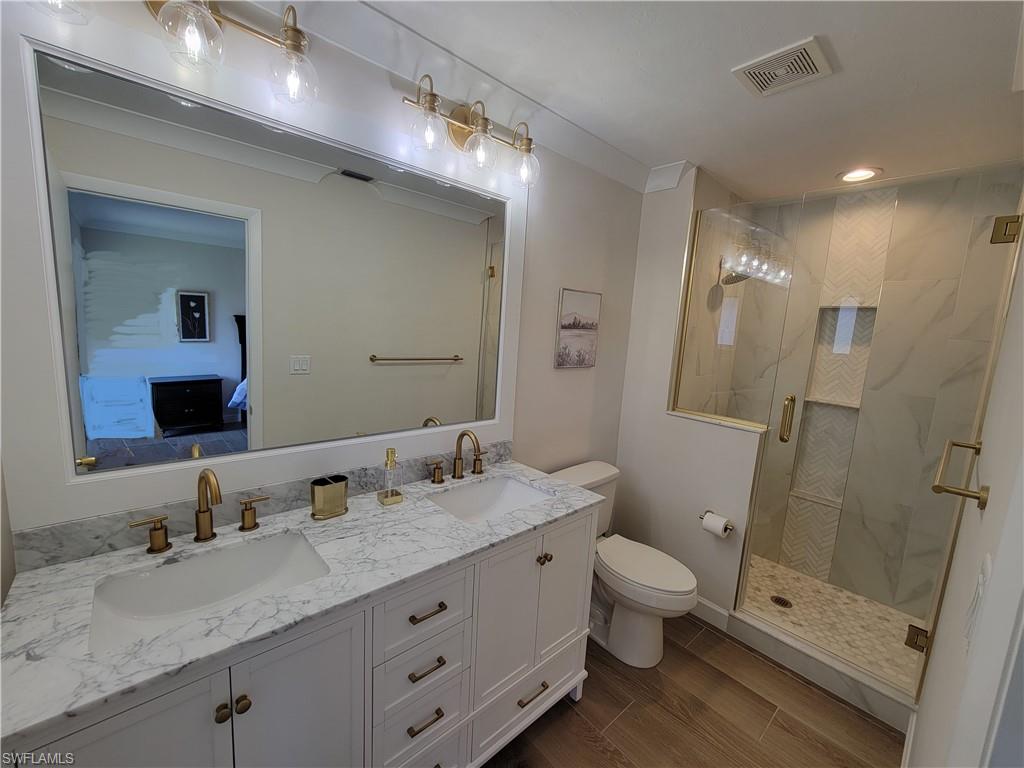 809 Palm View Drive, Unit 8 Naples, FL 34110 - Photo 14 of 26 a bathroom with a granite countertop sink a toilet and shower