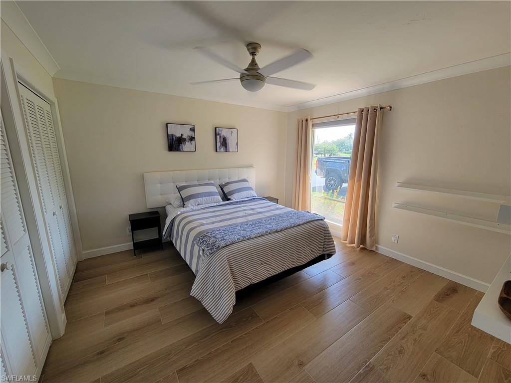 809 Palm View Drive, Unit 8 Naples, FL 34110 - Photo 17 of 26 a bedroom with a bed and a ceiling fan