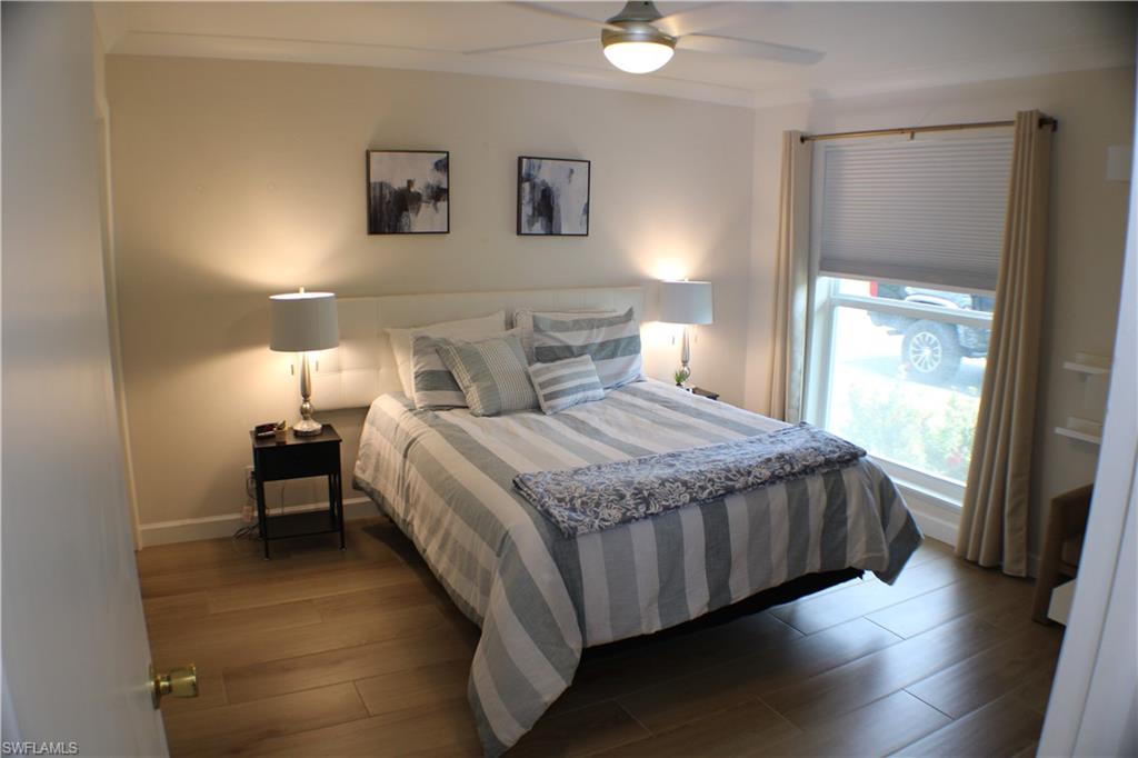 809 Palm View Drive, Unit 8 Naples, FL 34110 - Photo 18 of 26 a bedroom with a bed and a window