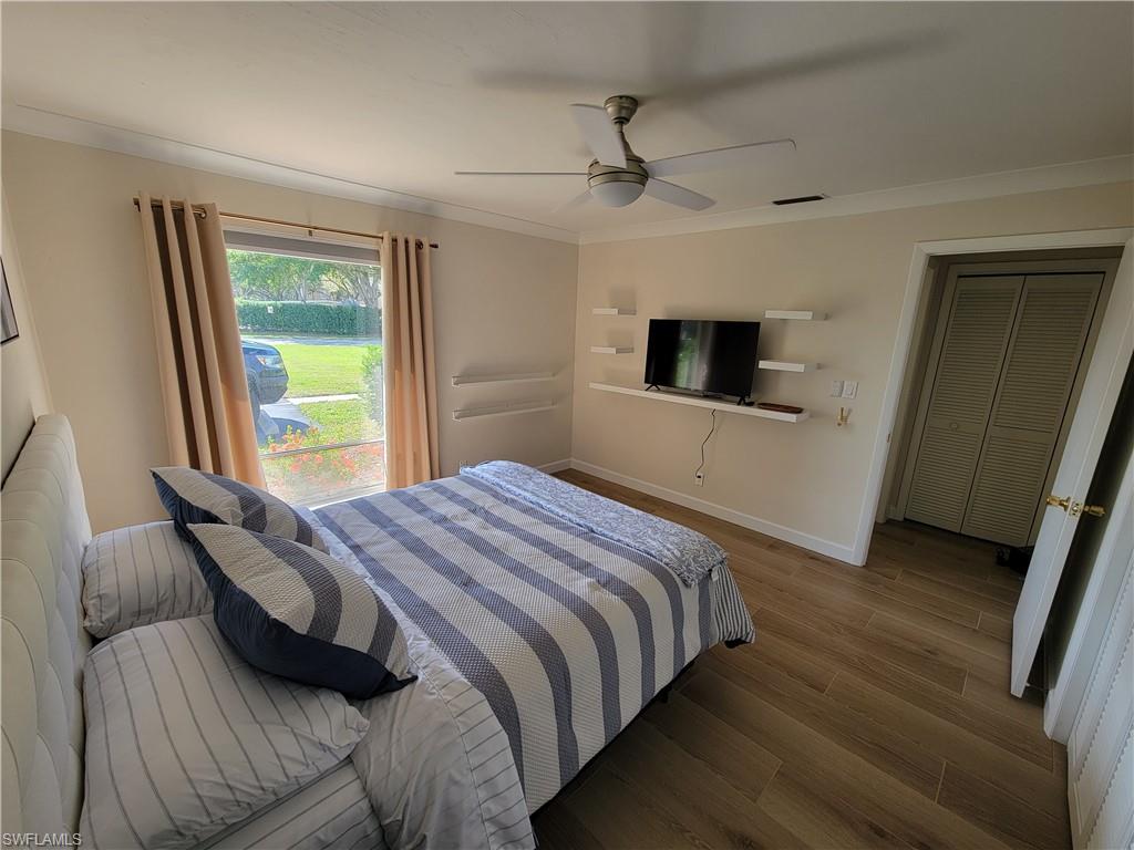809 Palm View Drive, Unit 8 Naples, FL 34110 - Photo 19 of 26 a bedroom with a bed and a large window