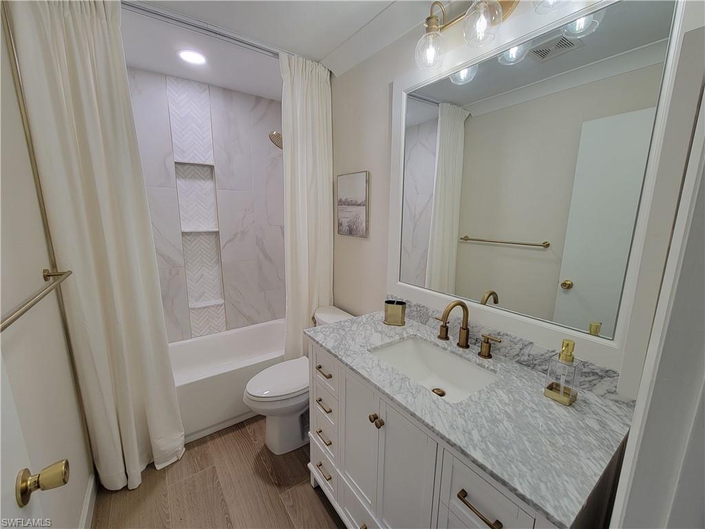 809 Palm View Drive, Unit 8 Naples, FL 34110 - Photo 22 of 26 a bathroom with a granite countertop sink a toilet and shower