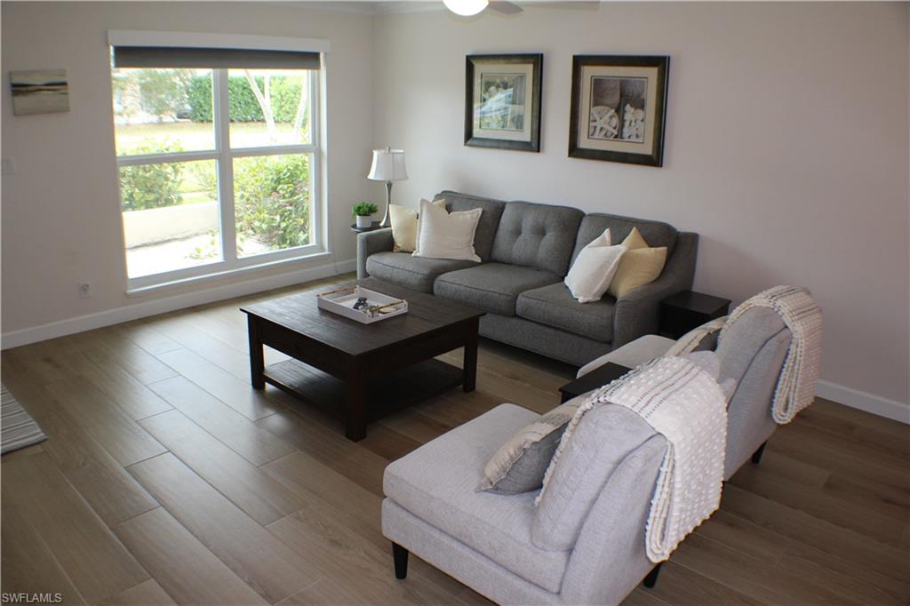 809 Palm View Drive, Unit 8 Naples, FL 34110 - Photo 6 of 26 a living room with furniture and a window