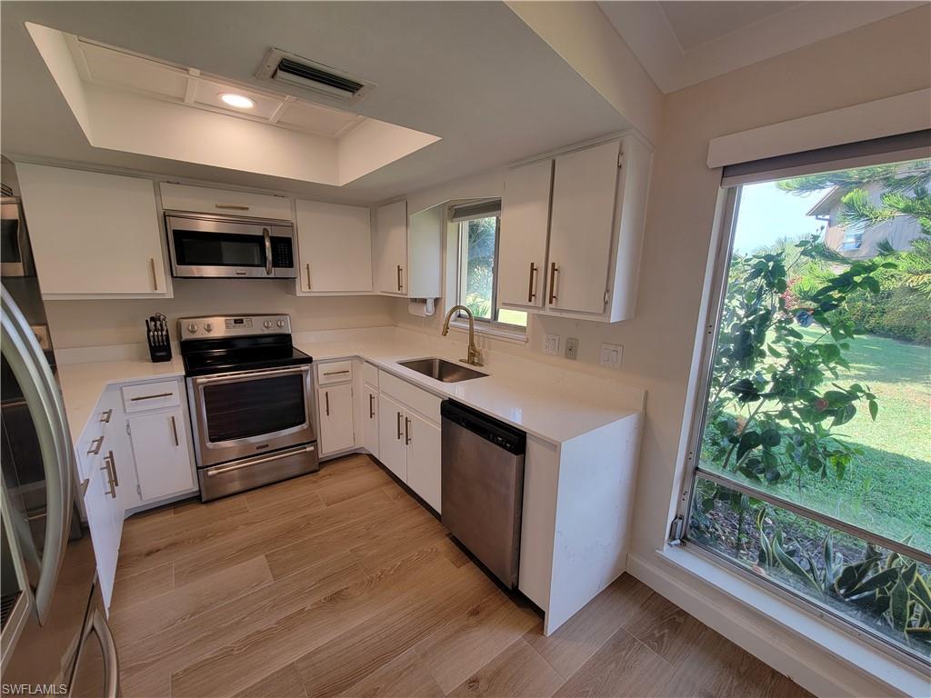 809 Palm View Drive, Unit 8 Naples, FL 34110 - Photo 10 of 26 a kitchen with a sink stove and microwave