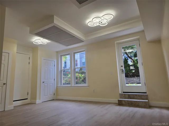 an empty room with windows and closet