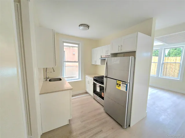 a kitchen with stainless steel appliances a refrigerator sink and cabinets