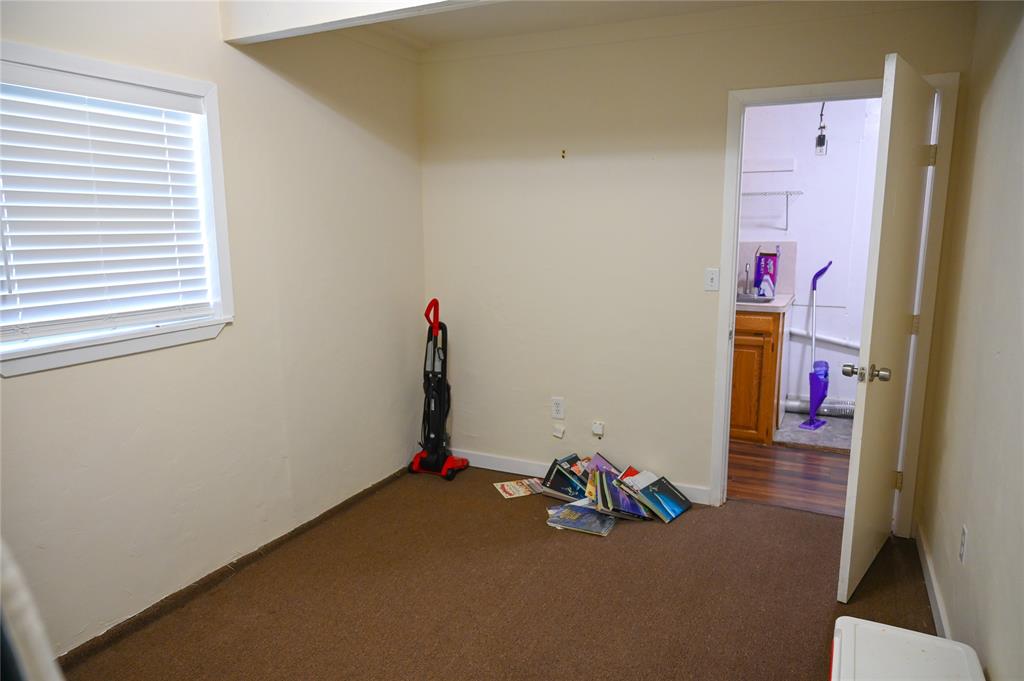 1352 Simpson Drive Hurst, TX 76053 - Photo 27 of 40 Room with warm beige wall paint and brown carpeting