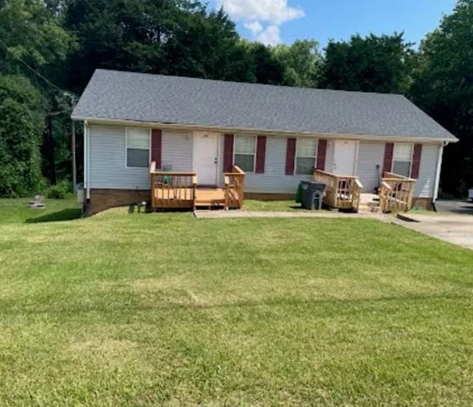 a view of a house with a yard and sitting area