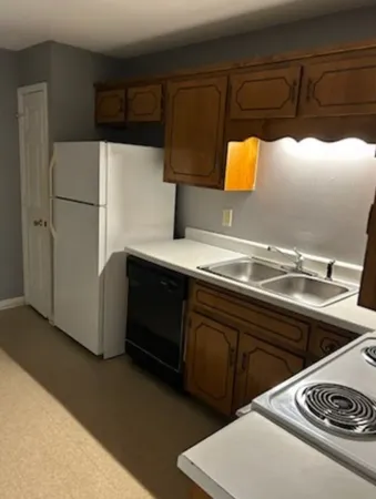 a kitchen with a sink and a refrigerator