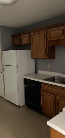 a kitchen with stainless steel appliances a refrigerator and cabinets