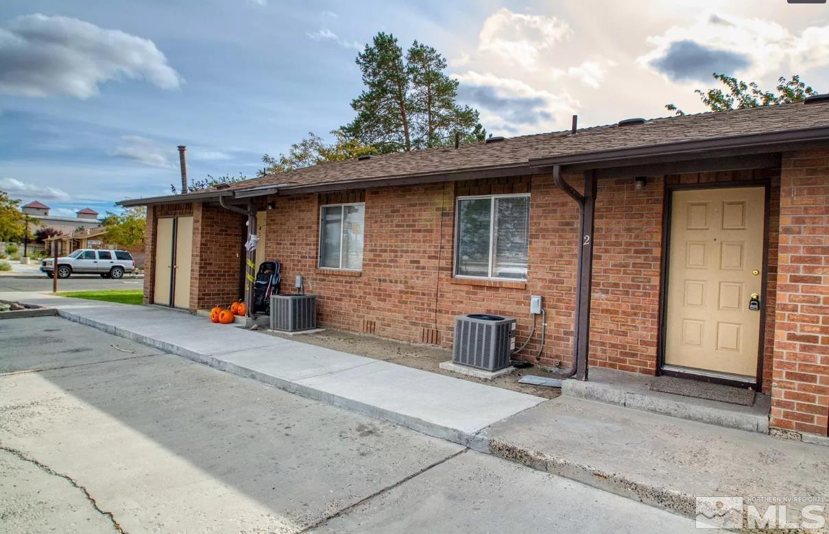360 Jill Court, Unit 6 Fernley, NV 89408 - Photo 1 of 9 a view of a house with a patio and a garage