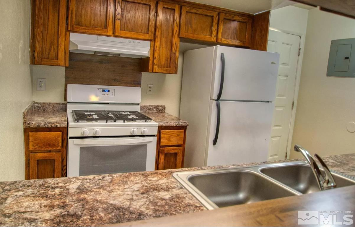 360 Jill Court, Unit 6 Fernley, NV 89408 - Photo 2 of 9 a kitchen with a sink stove and refrigerator