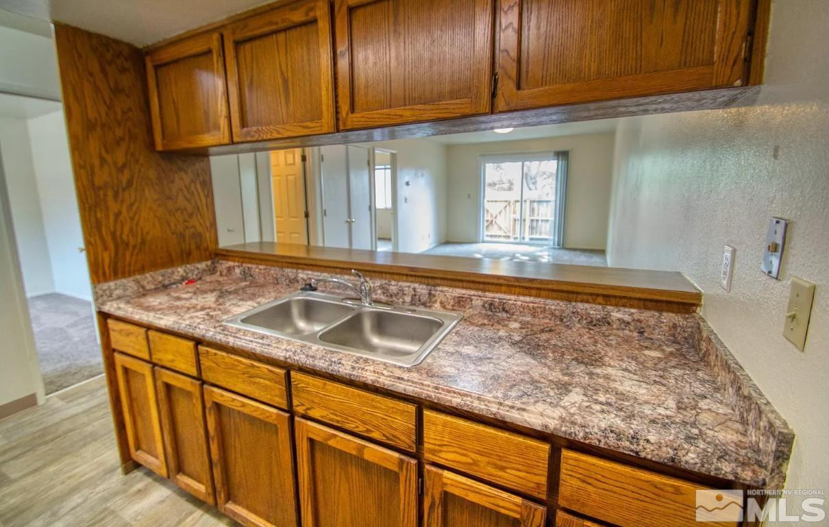 360 Jill Court, Unit 6 Fernley, NV 89408 - Photo 3 of 9 a view of a sink and dishwasher with wooden floor