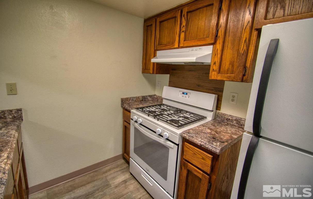 360 Jill Court, Unit 6 Fernley, NV 89408 - Photo 6 of 9 a stove top oven sitting inside of a kitchen