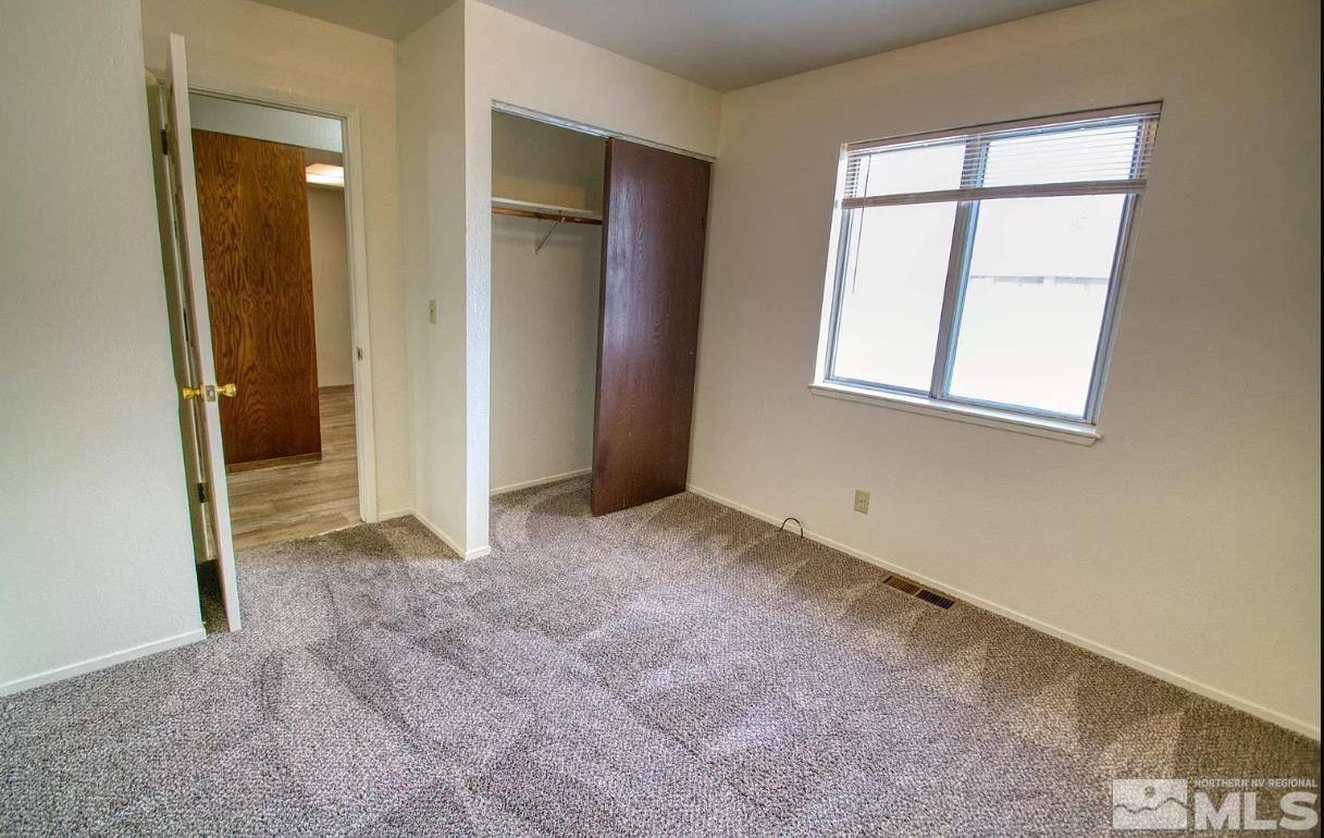 360 Jill Court, Unit 6 Fernley, NV 89408 - Photo 7 of 9 an empty room with windows and closet