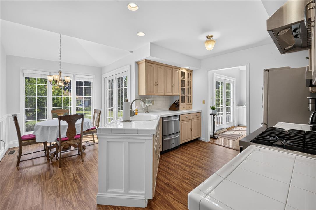 6467 Abbey Road Wind Gap, PA 18091 - Photo 14 of 46 A well-lit kitchen with wood flooring and French doors offers abundant natural light.