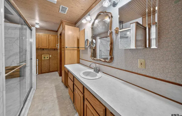a bathroom with a sink a double vanity and a mirror