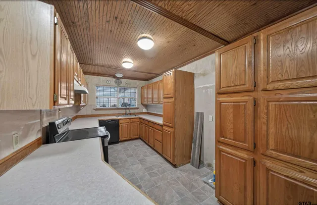 a kitchen with refrigerator and cabinets