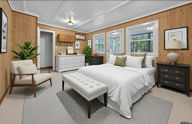 a bedroom with a large bed and a window