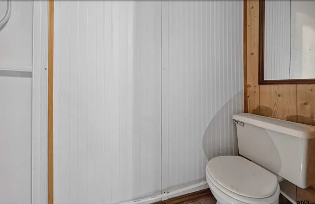 a white toilet sitting next to a shower