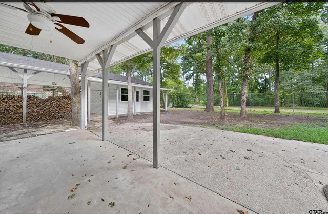 a view of a house with a backyard