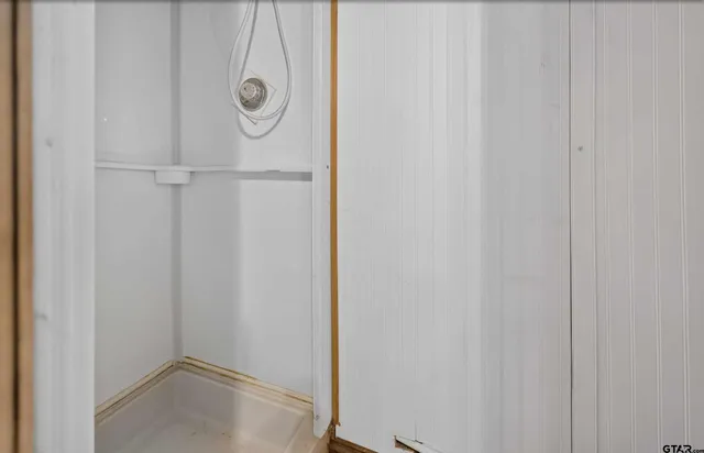 a bathroom with a glass shower door