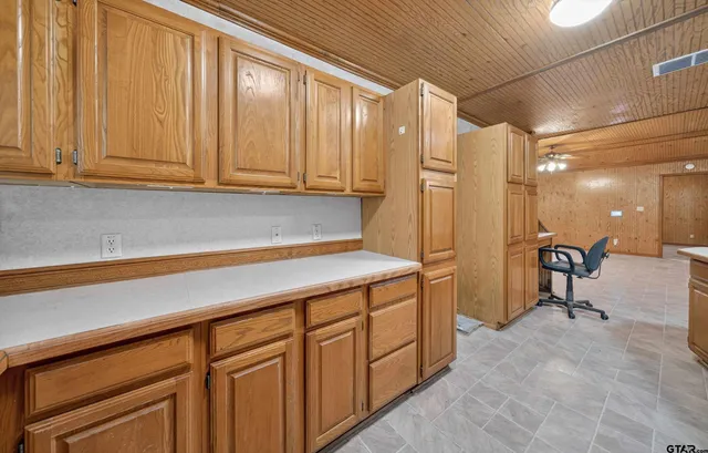 a kitchen with stainless steel appliances a refrigerator and cabinets