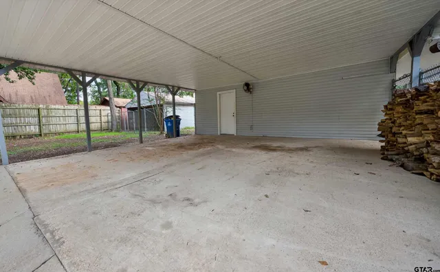 a view of a house with porch and floor to ceiling window