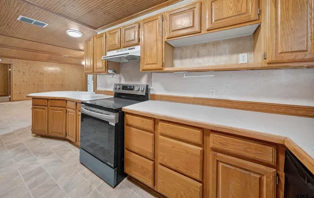 a kitchen with stainless steel appliances granite countertop a sink stove and cabinets